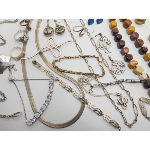 764 - A collection of silver and costume jewellery to include, heavy silver decorative chains, bangles, br... 