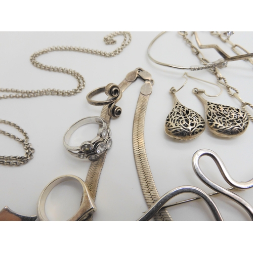 764 - A collection of silver and costume jewellery to include, heavy silver decorative chains, bangles, br... 