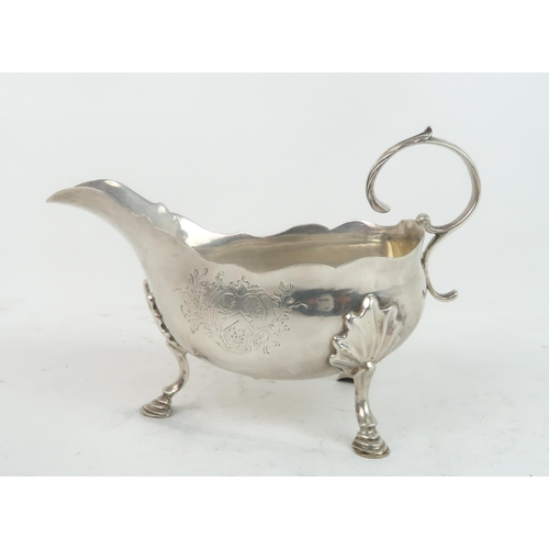 2470 - A GEORGE II SILVER SAUCE BOAT London 1755, maker's mark SM, of helmet form, the body with an engrave... 