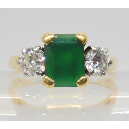 2703 - AN EMERALD AND DIAMOND RINGthe 18ct gold ring set with a step cut emerald 8mm x 6mm, and two diamond... 