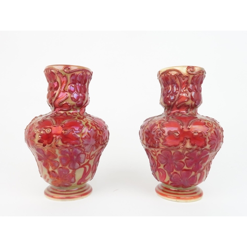 2174 - A PAIR OF LATE 19TH CENTURY CRAVEN DUNNILL JACKFIELD POTTERY VASESwith red lustre glaze over relief ... 