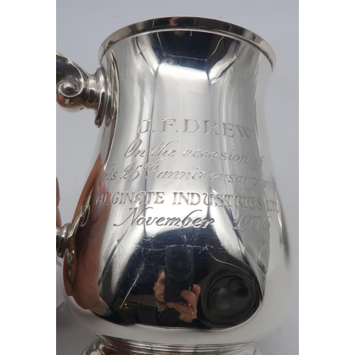 270 - An Elizabeth II silver tankard, of flaring cylindrical form, with an acanthus double scroll handle, ... 