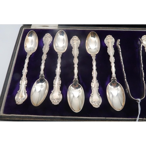 286C - A cased set of silver tea spoons and sugar tongs,  with moulded scrollwork borders, by Gorham M... 