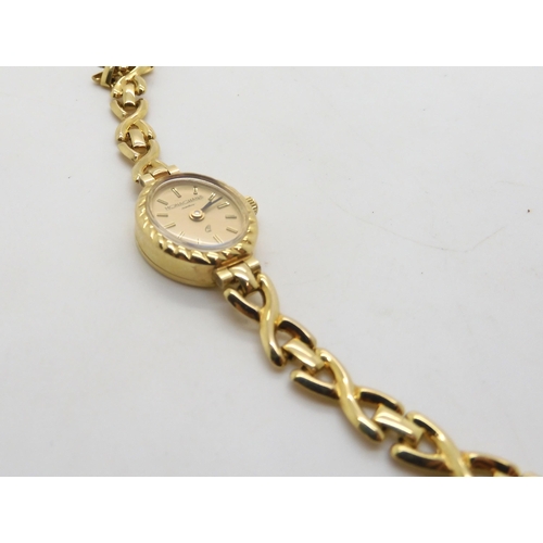 520 - A 9ct gold ladies watch the dial signed Monaghans Jewellers, weight including mechanism 9.6gms