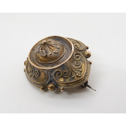 522 - A Victorian yellow metal Etruscan revival style brooch with locket back, length 4.5cm, weight 11.1gm... 