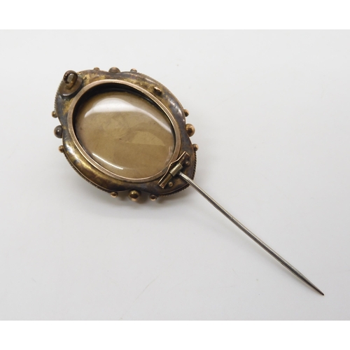 522 - A Victorian yellow metal Etruscan revival style brooch with locket back, length 4.5cm, weight 11.1gm... 