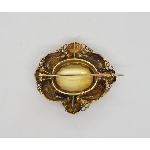 524 - A yellow metal filigree brooch set with a large citrine of approx 23mm x 1.8mm, weight 13.3gms