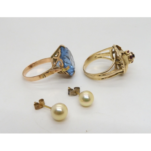 527 - An Arabic gold ring set with a large blue gem, size P, and a 9ct gold ruby and sapphire ring  s... 