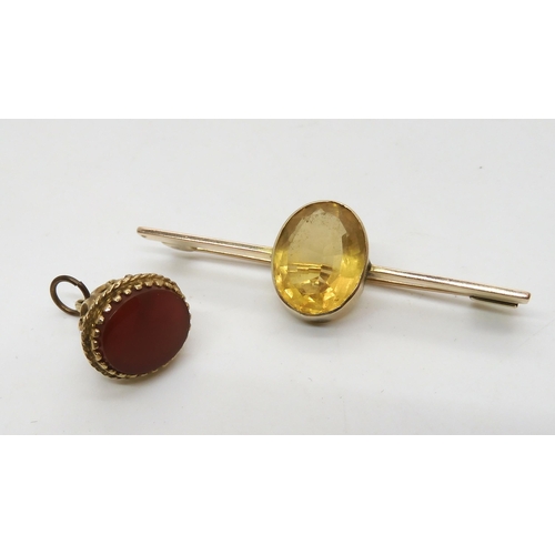 536 - A 9ct gold fob seal and a yellow metal bar brooch set with a citrine, weight 9.5gms