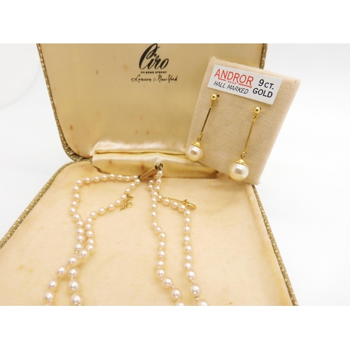 543 - A double string of Ciro faux pearls in original box with a 9ct clasp, a 9ct bangle, a Lincoln imp br... 