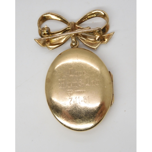 546 - A 9ct gold locket brooch with bow mount, a 9ct gold bangle and a brooch, weight together 15gms