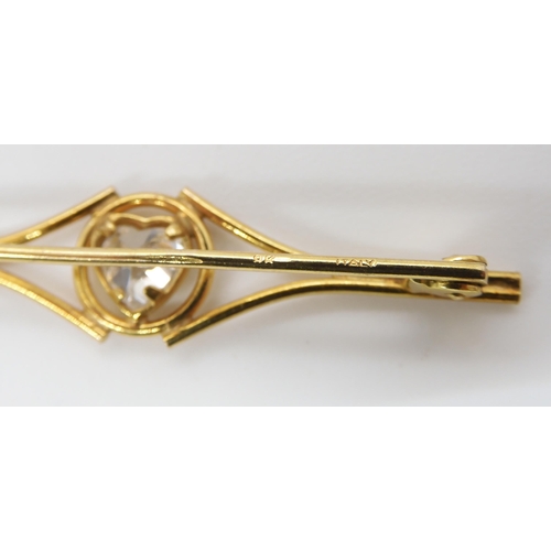 546 - A 9ct gold locket brooch with bow mount, a 9ct gold bangle and a brooch, weight together 15gms