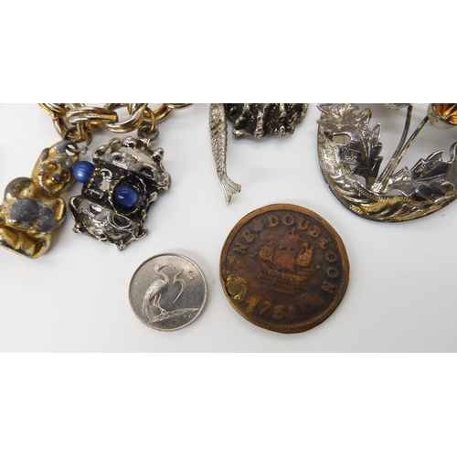 572 - A 1751 One Dubloon gaming token, a silver Ward Brothers thistle brooch, a brass dog ornament and a c... 