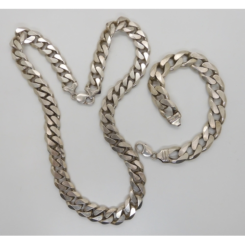 574 - A long and heavy silver curb chain necklace with similar bracelet, length of necklace 61.5cm, bracel... 