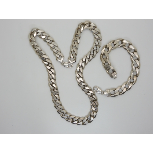 574 - A long and heavy silver curb chain necklace with similar bracelet, length of necklace 61.5cm, bracel... 