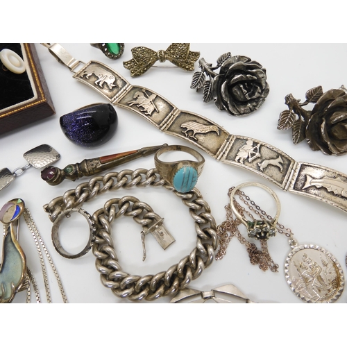 576 - Two Norman Grant items, a titanium dragonfly pendant, and a enamelled performing seal brooch both st... 