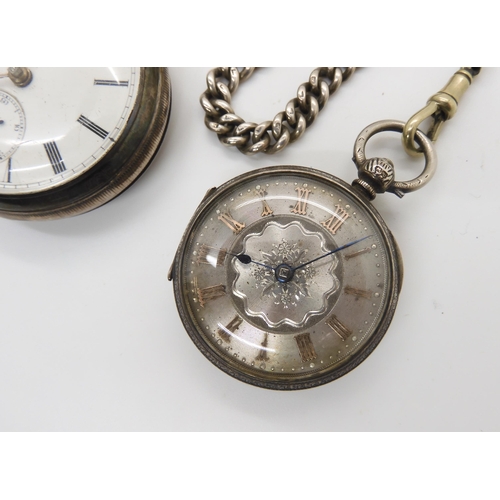 577 - A silver open face pocket watch with a decorative silver dial, and silver fob chain, diameter of the... 