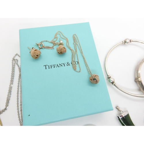 582 - A Tiffany & Co knot pendant and matching earrings, both signed, together with other items of sil... 