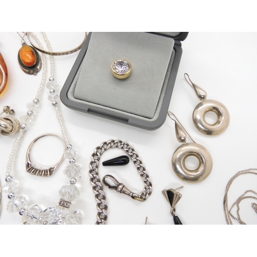 588 - A collection of silver and white metal jewellery to include amber set items, two retro pendants and ... 