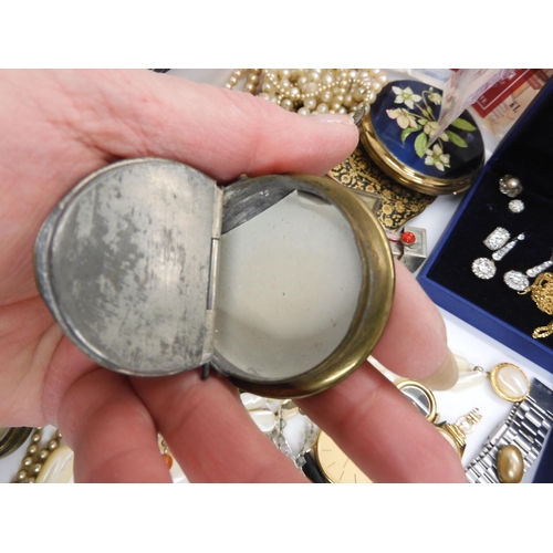 592 - A collection of compacts to include a Navy cap example, a white metal sliding lipstick and mirror co... 