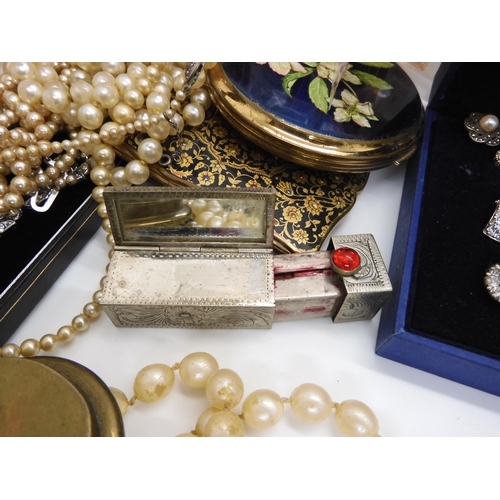 592 - A collection of compacts to include a Navy cap example, a white metal sliding lipstick and mirror co... 