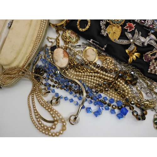 596 - A large collection of vintage brooches, beads, necklaces etc