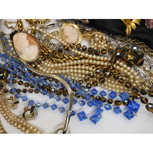 596 - A large collection of vintage brooches, beads, necklaces etc