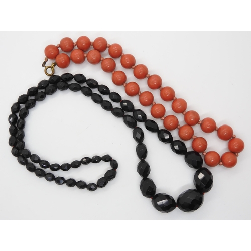 602 - A string of coral beads, each bead approx 11.5mm, weight 32.5gms, together with a dark cherry amber ... 