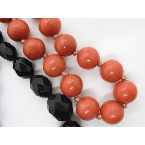 602 - A string of coral beads, each bead approx 11.5mm, weight 32.5gms, together with a dark cherry amber ... 