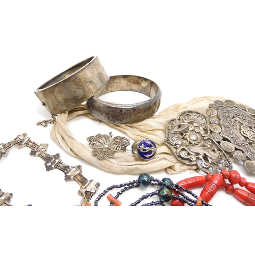 604 - Two silver bangles, a Max Neiger red glass bead necklace, a Chinese silver buckle, and other items