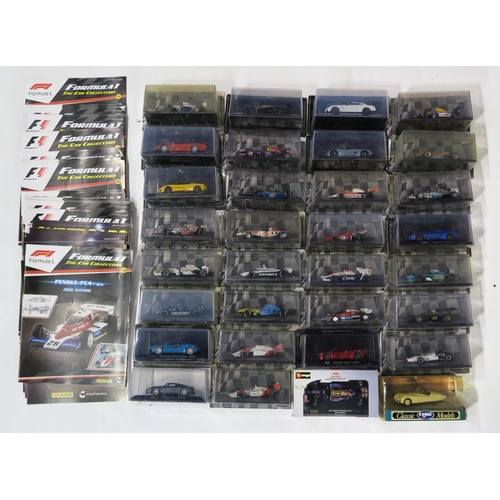 386 - A quantity of Formula 1: the Car Collection model cars by Panini, still packaged, with corresponding... 