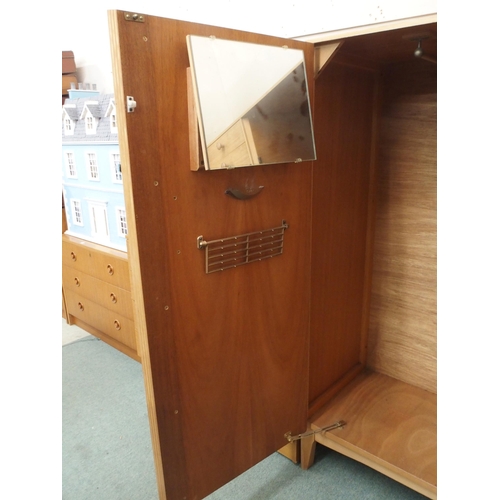 44 - A mid 20th century teak veneered Remploy bachelors wardrobe, 135cm high x 90cm wide x 47cm deep and ... 