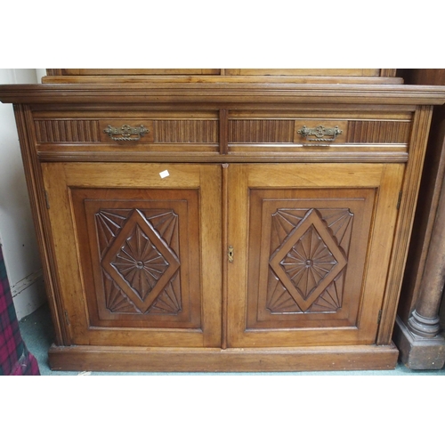 56 - A Victorian mahogany bookcase on base with moulded cornice over pair of glazed doors over drawers ov... 