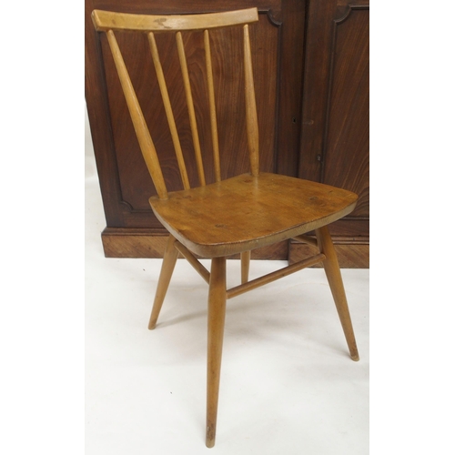 79 - A pair of mid 20th century elm and beech Ercol model 608 rail back chairs, carved circular topped st... 