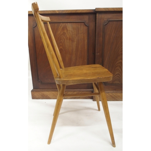 79 - A pair of mid 20th century elm and beech Ercol model 608 rail back chairs, carved circular topped st... 