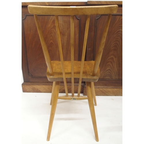 79 - A pair of mid 20th century elm and beech Ercol model 608 rail back chairs, carved circular topped st... 