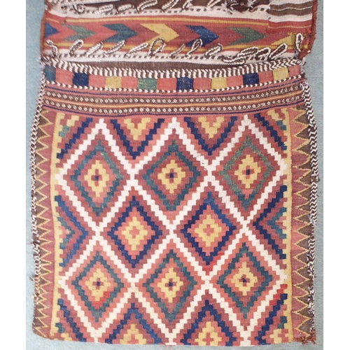 85 - A multicoloured ground Kilim saddle bag with all-over geometric design, 157cm long x 67cm wide