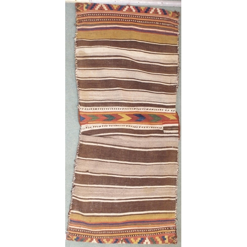 85 - A multicoloured ground Kilim saddle bag with all-over geometric design, 157cm long x 67cm wide