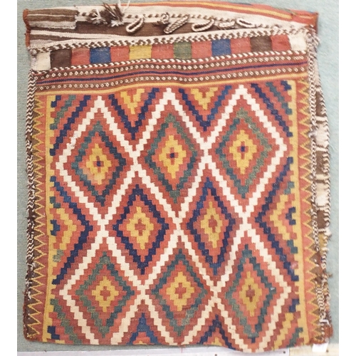 85 - A multicoloured ground Kilim saddle bag with all-over geometric design, 157cm long x 67cm wide