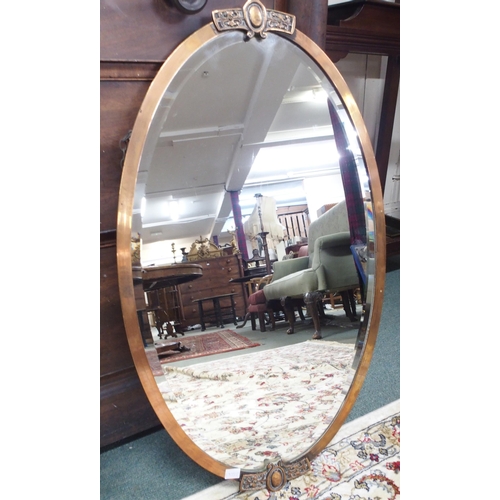 86 - A Victorian mahogany framed oval wall mirror, 59cm high x 94cm wide, a copped framed bevelled glass ... 