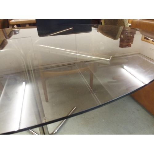 87 - A mid 20th century oval smoked glass top table on steel base, 71cm high x 124cm long x 91cm deep