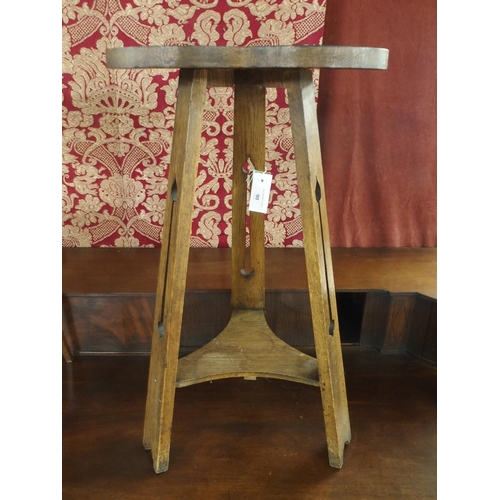 90 - An early 20th century oak Liberty & Co style trefoil topped tripod table with pierced supports j... 