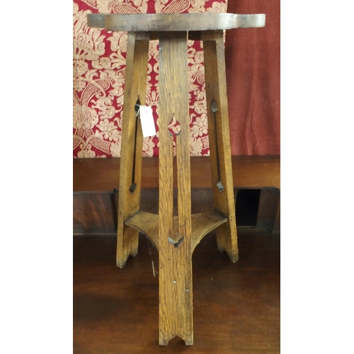 90 - An early 20th century oak Liberty & Co style trefoil topped tripod table with pierced supports j... 