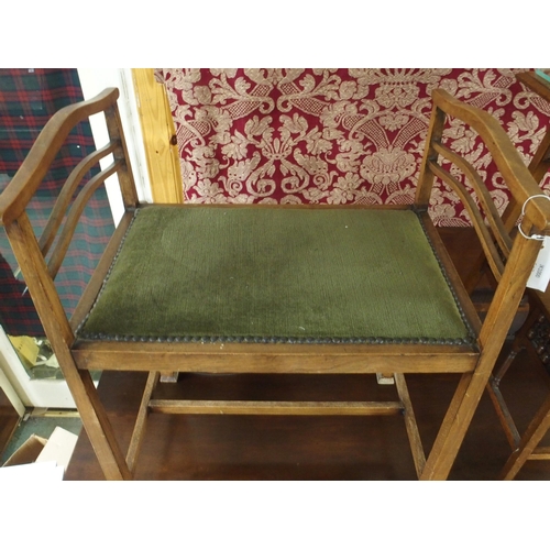 92 - An early 20th century oak arts and crafts piano stool with green upholstered seat on stretchered squ... 