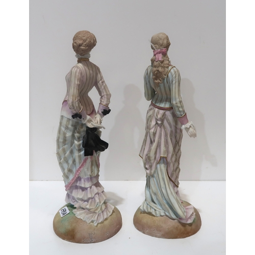 171A - A pair of bisque figures of ladies in Victorian dress with diamond registration mark for 1879