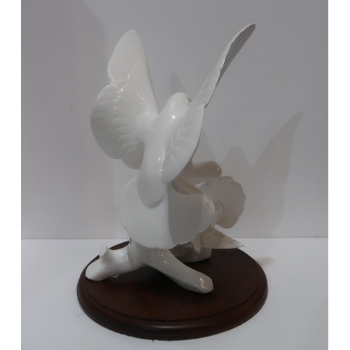 184 - A large white glazed Royal Doulton Images sculpture of two doves, titled The Homecoming