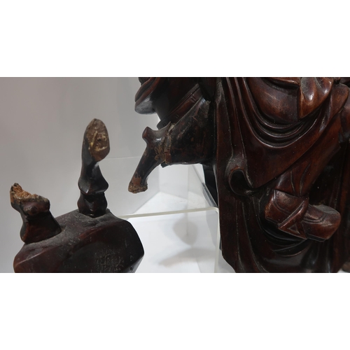 193 - A pair of Chinese carved figures on horseback and a wall mask