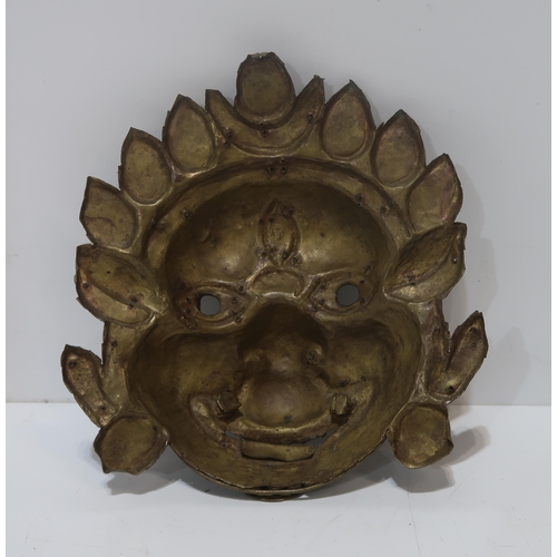 199 - A Tibetan metal mask with glass bead decoration