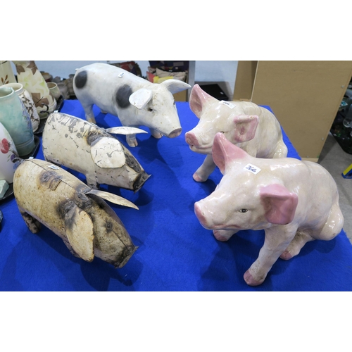 266 - A pair of pottery pigs, a composite pig and two metal examples