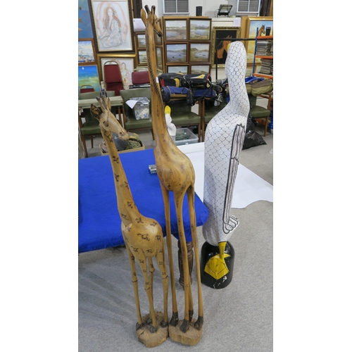 278 - A large painted wooden model of a goose, 148cm tall, two others smaller and two wooden Giraffes